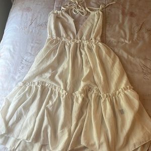 It is a beautiful white dress, size medium and open from the back